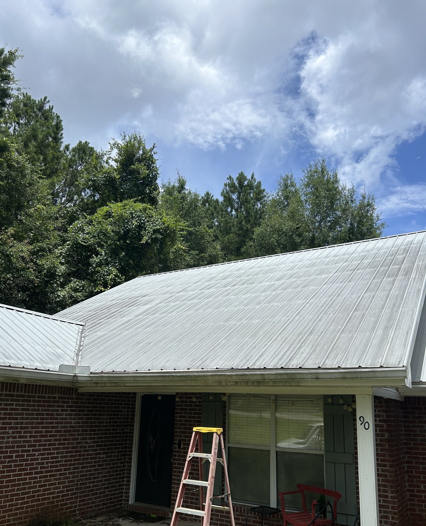 Metal roof soft wash on a brick ranch, before